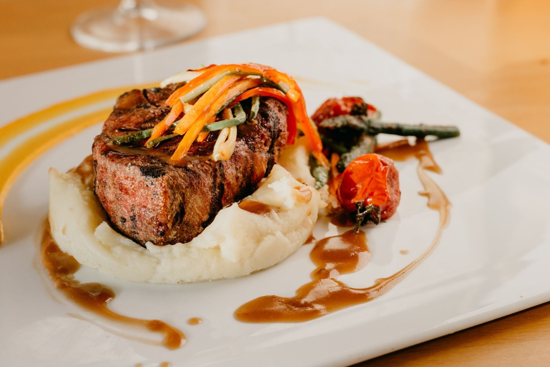 ostrich steak atop mashed potatoes