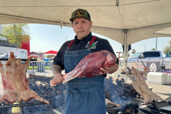 Victor Perez with whole ostrich leg, photo courtesy of Official Open Fire Cooking