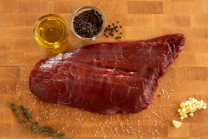 raw ostrich fan filet with olive oil, pepper and garlic