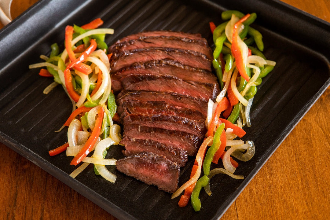 cooked ostrich fan filet with peppers and onions