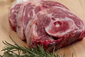 Raw lamb neck slices on a cutting board