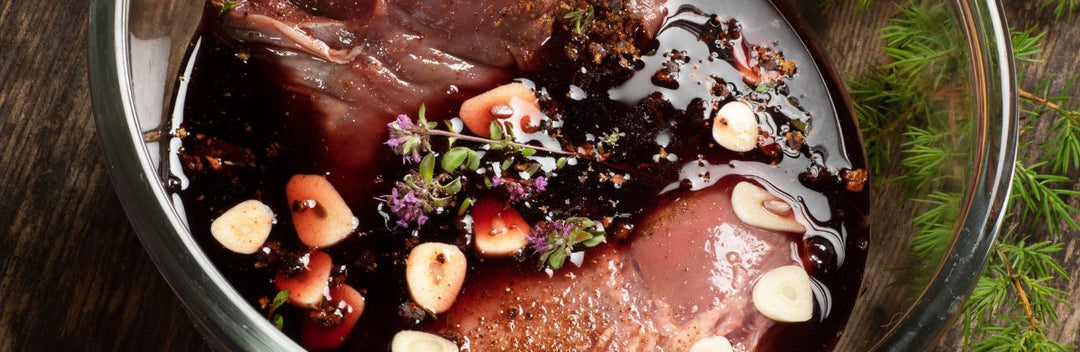 ostrich marinating in red wine with garlic and thyme