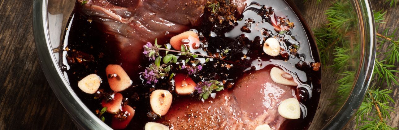 ostrich marinating in red wine with garlic and thyme