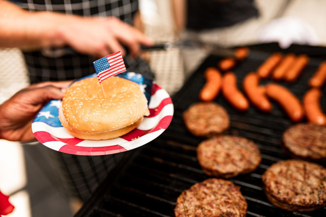 ostrich burgers on grill with a bun on a USA plate
