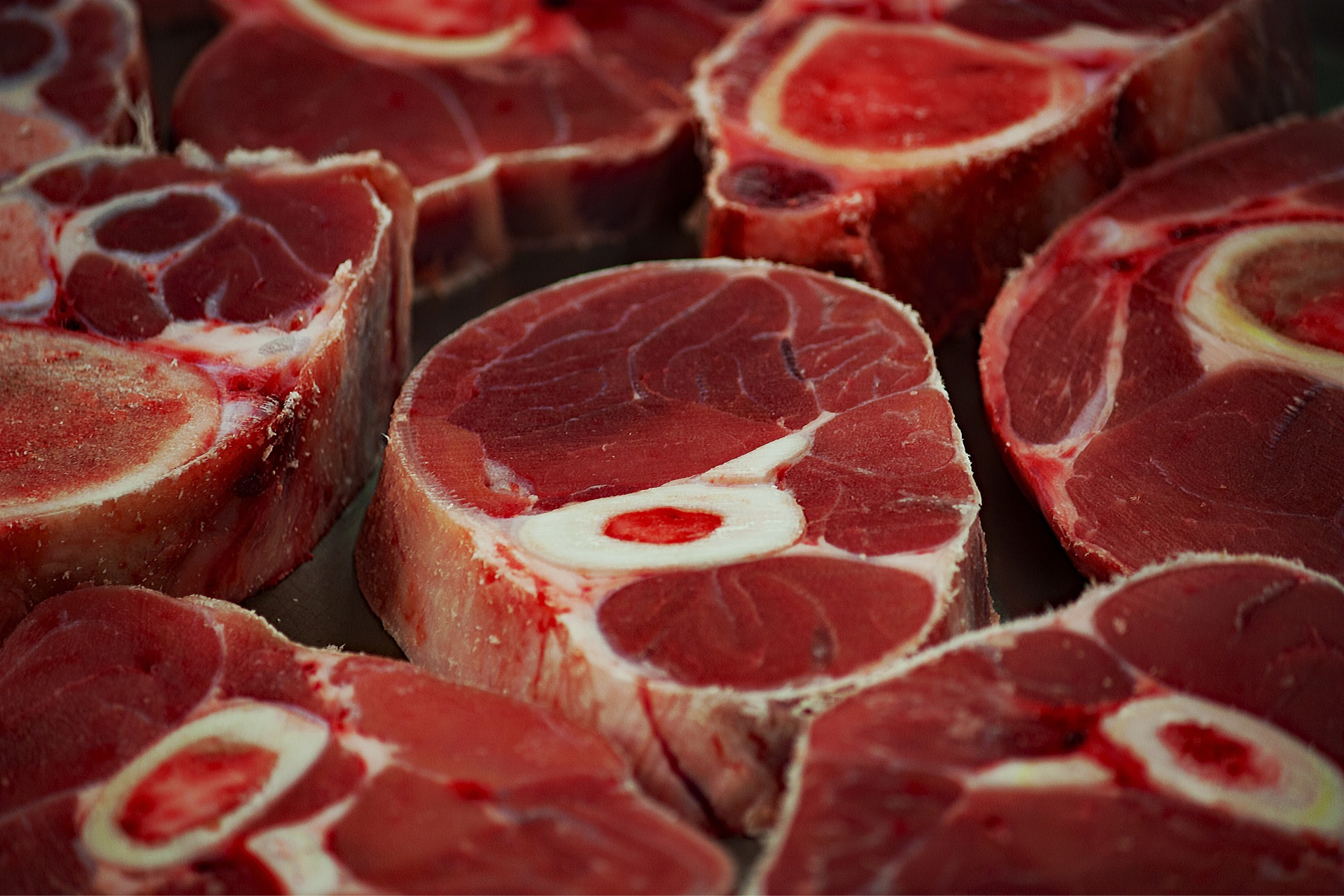 Picture of multiple slabs of sliced meat rounds.