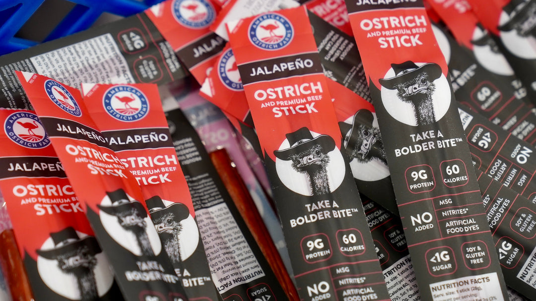 a crate full of jalapeno flavored ostrich and beef meat snack sticks