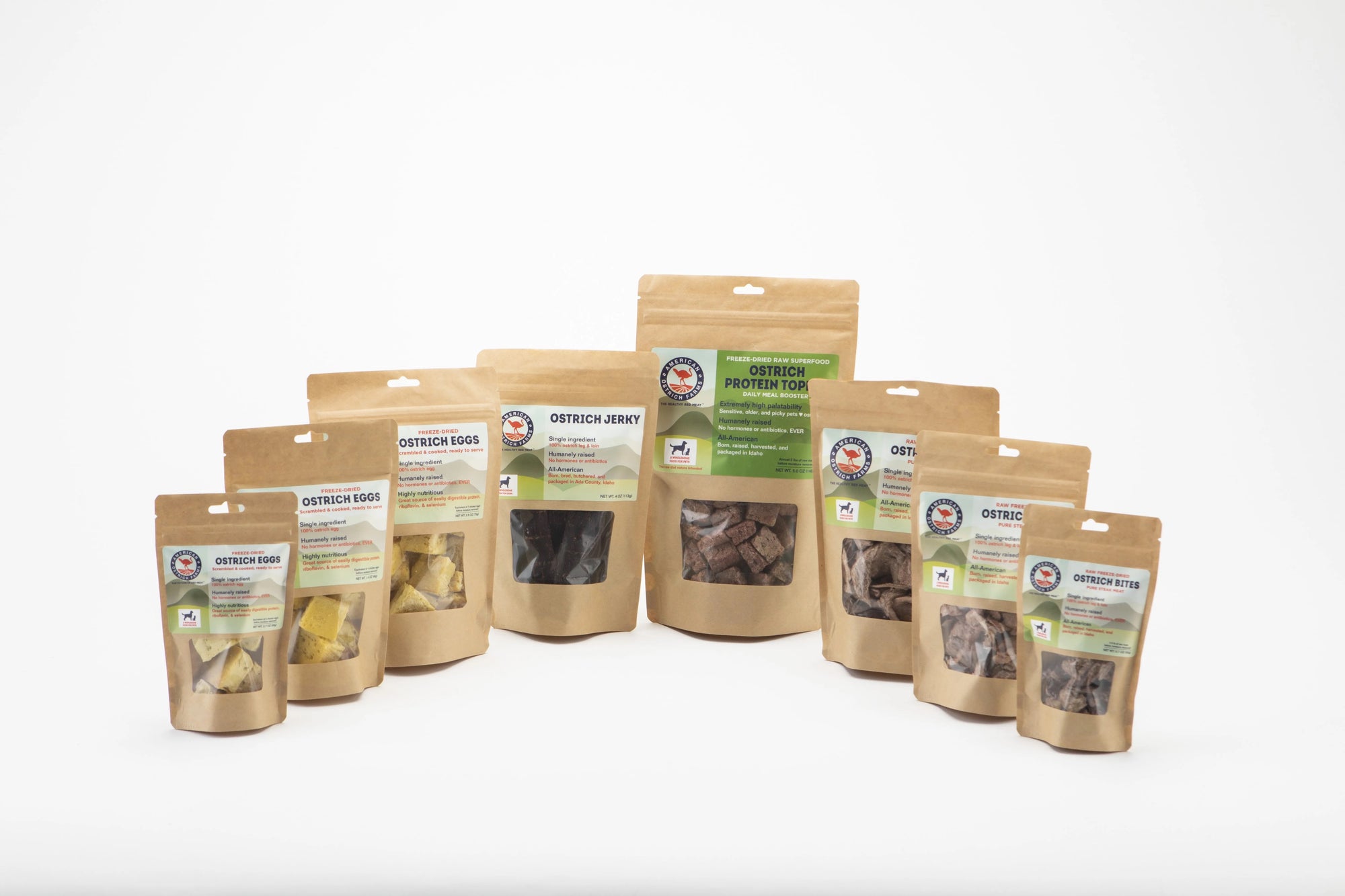 packages of ostrich pet treats, including freeze-dried egg, jerky, protein topper, freeze-dried organ, and freeze-dried steak bites