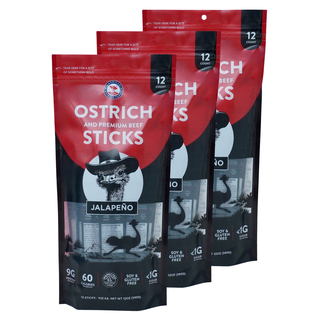 Three 12-pack bags of Jalapeno Flavor Ostrich and Premium Beef Sticks, featuring red and black resealable pouches with a cartoon ostrich wearing a cowboy hat.