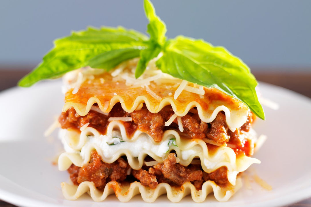 healthy classic lasagna with ground ostrich meat sauce topped with fresh basil
