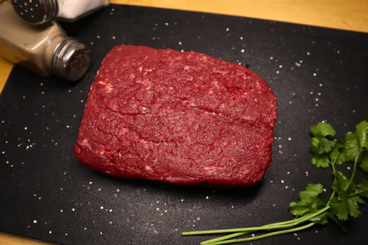 black label raw ground ostrich meat on cutting board