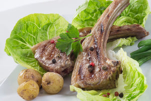 lamb loin chops served on a bed of greens