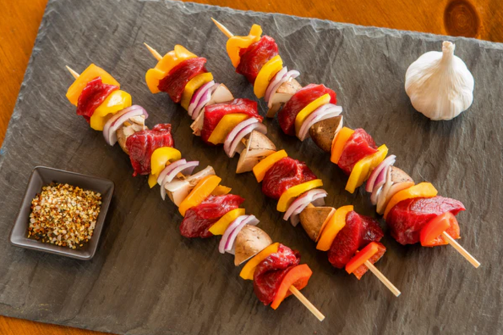 raw ostrich kebab meat on skewers