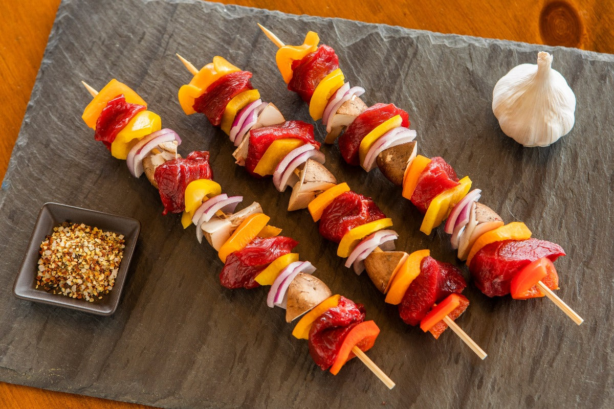 cooked shish kabobs with ostrich round peppers and onions