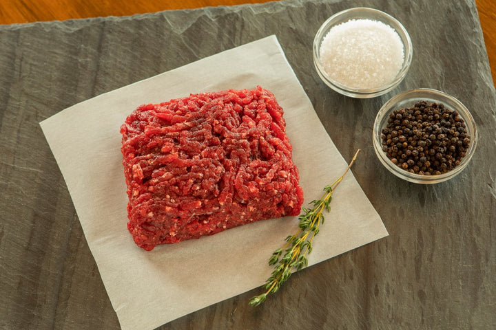 raw ground ostrich steak with salt and pepper