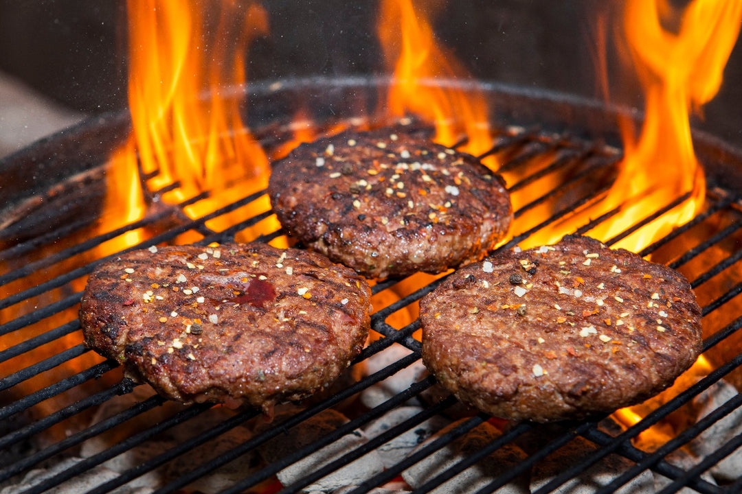 3 ground ostrich steak patties on grill