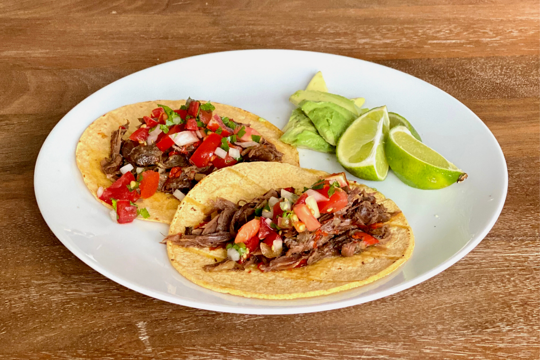 2 street tacos made with shredded ostrich neck meat